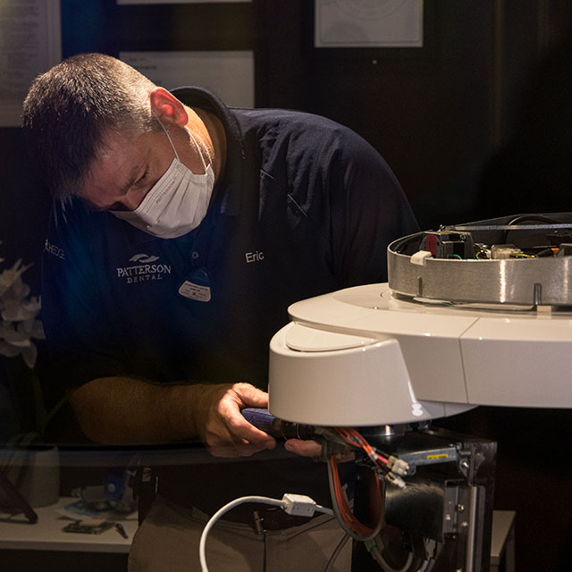 Dentsply Sirona technician installs panels onto the new Axeos™ imaging machine.