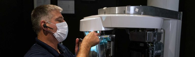 A Dentsply Sirona technician installs the new Axeos™ imaging machine