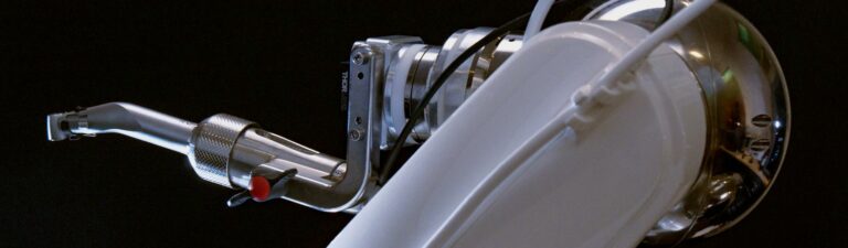 The arm of the Yomi robotic assistant is shown. Blog banner for the introduction to Yomi® robotic dentistry blog post.